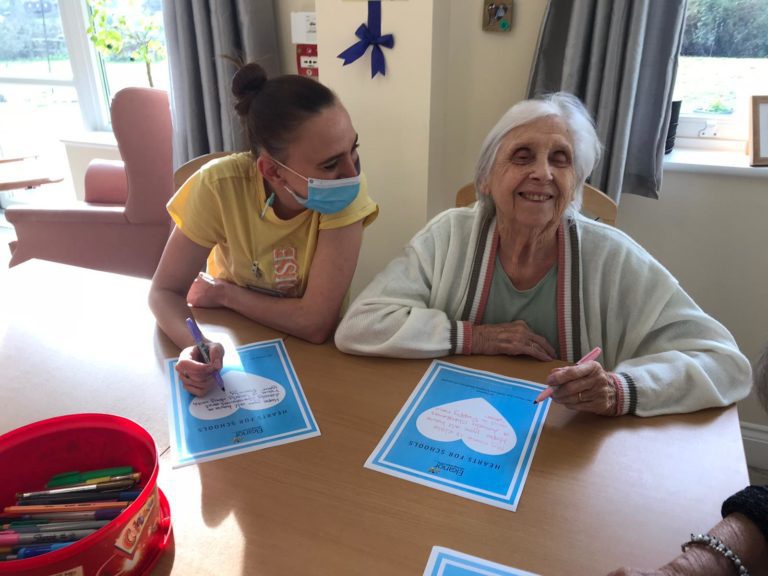 Resident Drawing with Carer at Roselands Residential Care Home